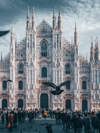 A panoramic view of Milan’s cityscape, featuring the iconic Milan Cathedral (Duomo di Milano) and the bustling streets filled with historic and modern architecture.